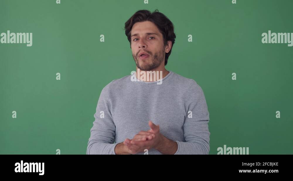 Bored man clapping hands over green screen Stock Video Footage Alamy