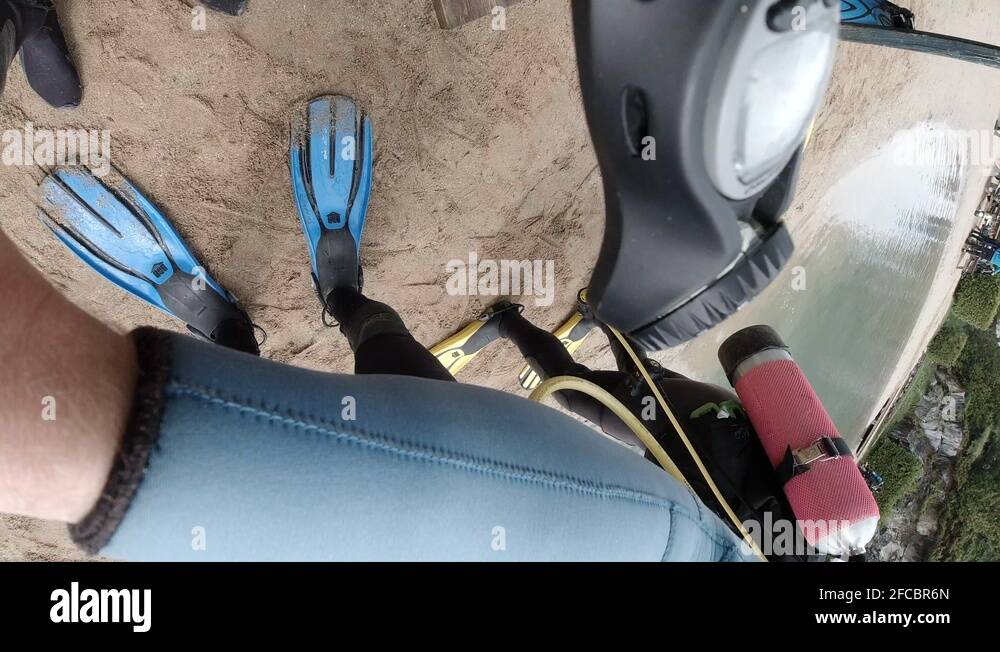 Scuba divers preform buddy safety check before entering water First