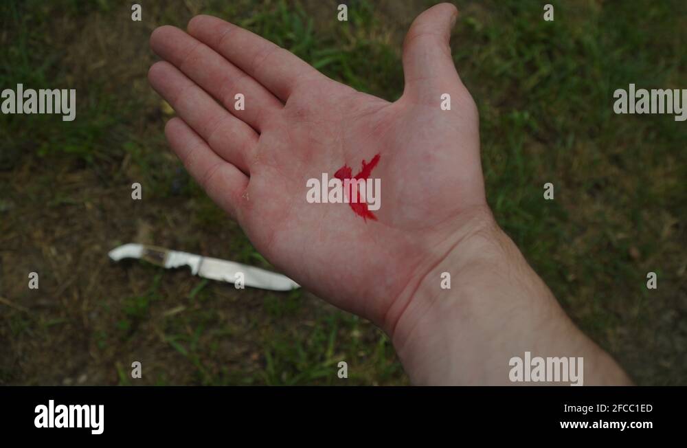 Accidental minor cut on hand, knife laying on the ground Stock Video