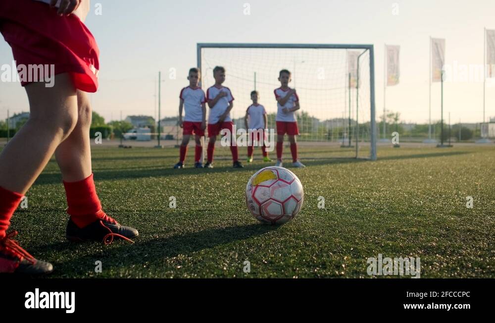 Boy footballer is kicking ball through wall of players Stock Video