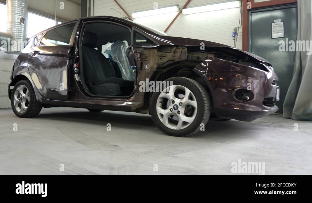 Car damaged in an accident is in the autobody shop for repairs Stock