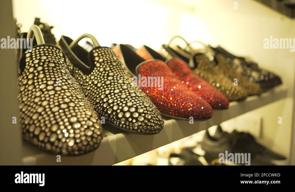 a luxury shoe rack in a dressing room full of expensive shoes Stock
