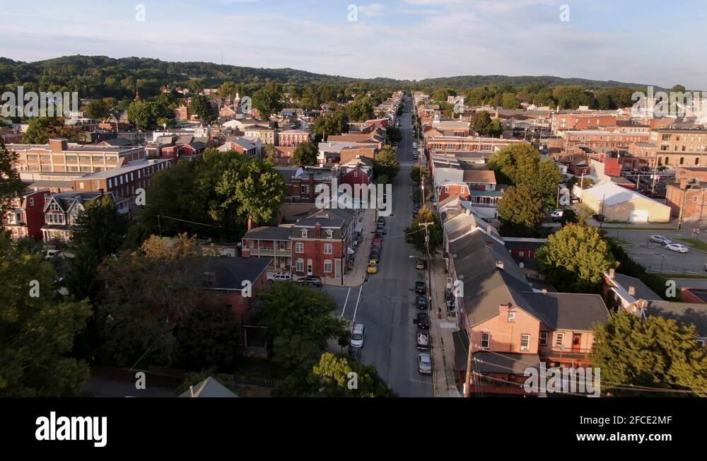 Cinematic drone aerial tracking street in small town America ...