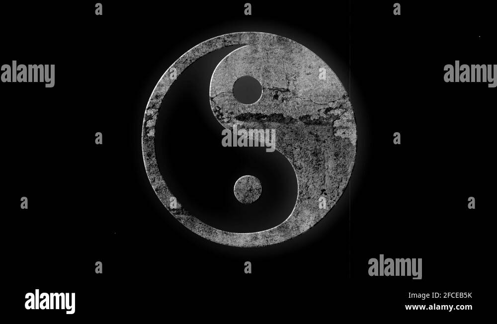 White Yin Yang symbol made of stone on a black background with blinking ...