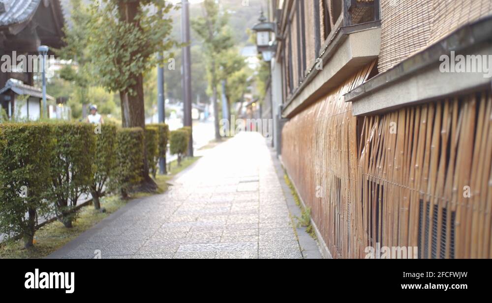 Japanses sidewalk early in the morning with bamboo walls in Kyoto ...