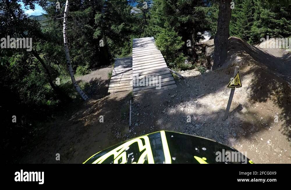 Crazy MTB jumping over high ramp in mountain bike action park. France