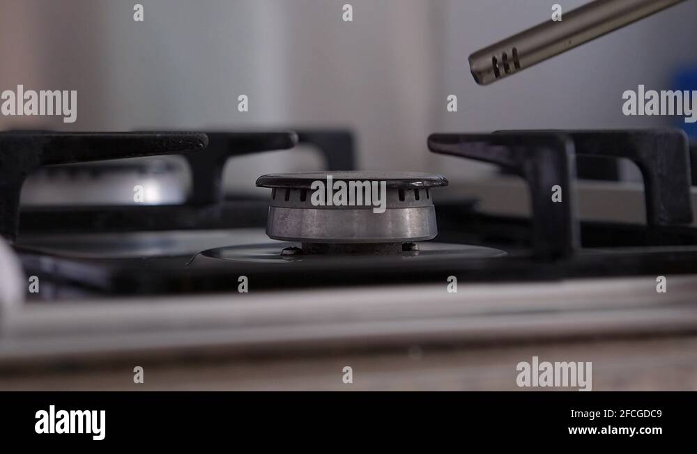 Close shot of the turning on the gas burner in slow mo. Blurred