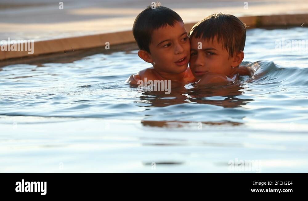 Two brothers together at the swimming pool Stock Video Footage - Alamy