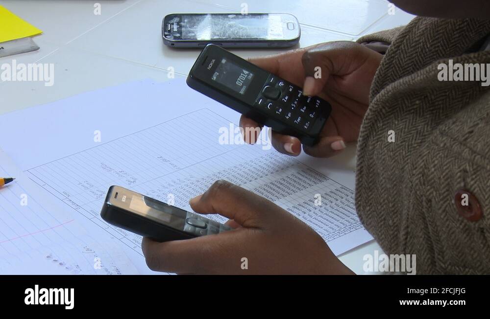 Kenyan worker Using old Nokia mobile phones in a Startup in Nairobi