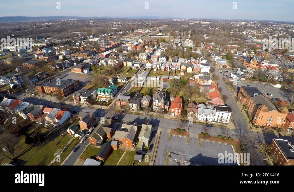 Turning aerial view of neighborhoods and downtown area in Martinsburg