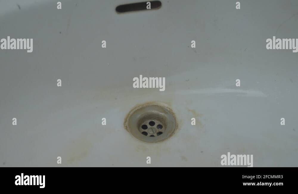 Water pouring down drain of dirty sink Stock Video Footage Alamy
