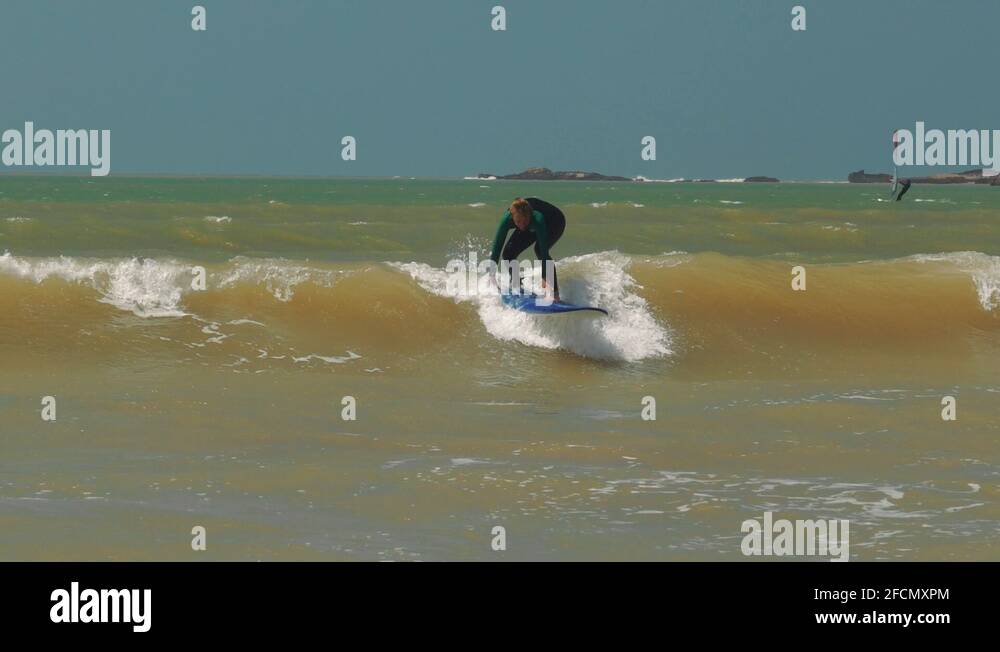 Beginner surfer girl falling off surfboard into waves, Morocco, Essaoiura Stock Video Footage