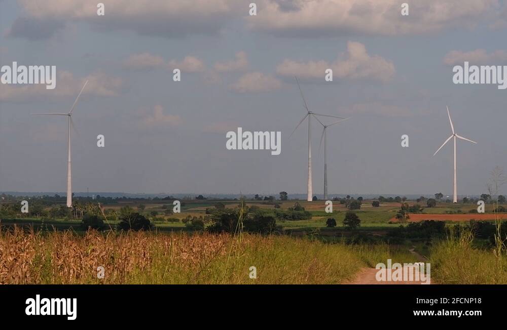 Wind Turbines Towering Farmlands, as farmers grow their crops and tend