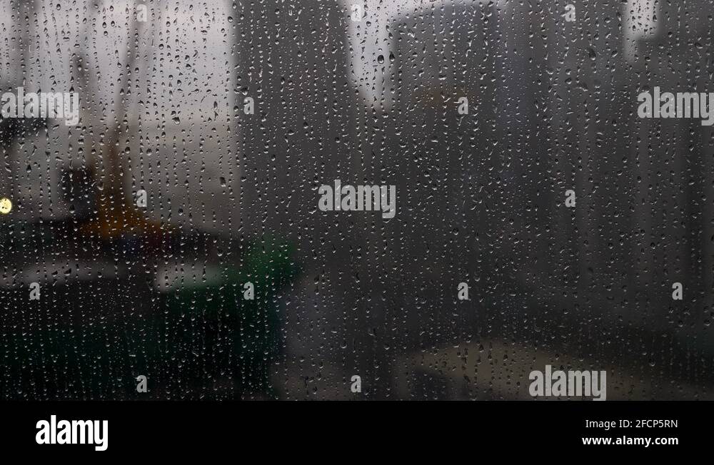 Raindrops sliding down the window of apartment. Static. Blur background Stock Video Footage Alamy