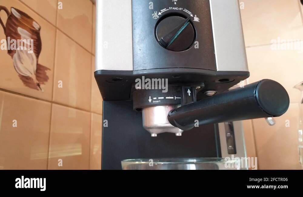 Broken espresso machine making espresso coffee. Coffee pouring from