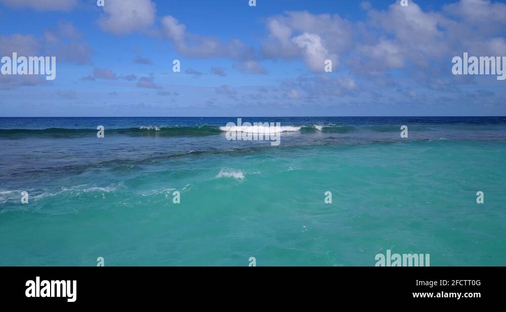 Static tripod on a beach in the tropic with fluffy clouds on the ...