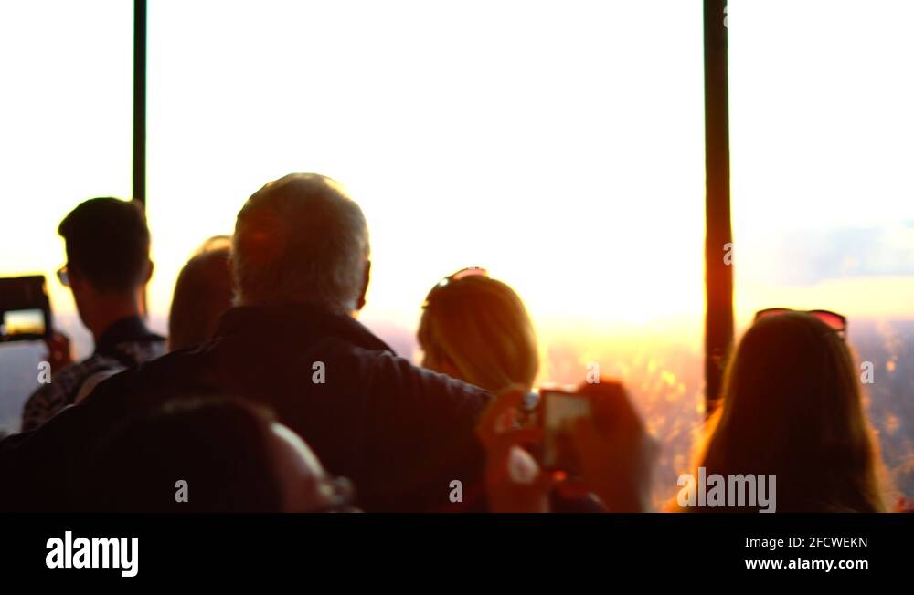 People Appreciating the Beautiful Summer Evening on top of CN Tower of