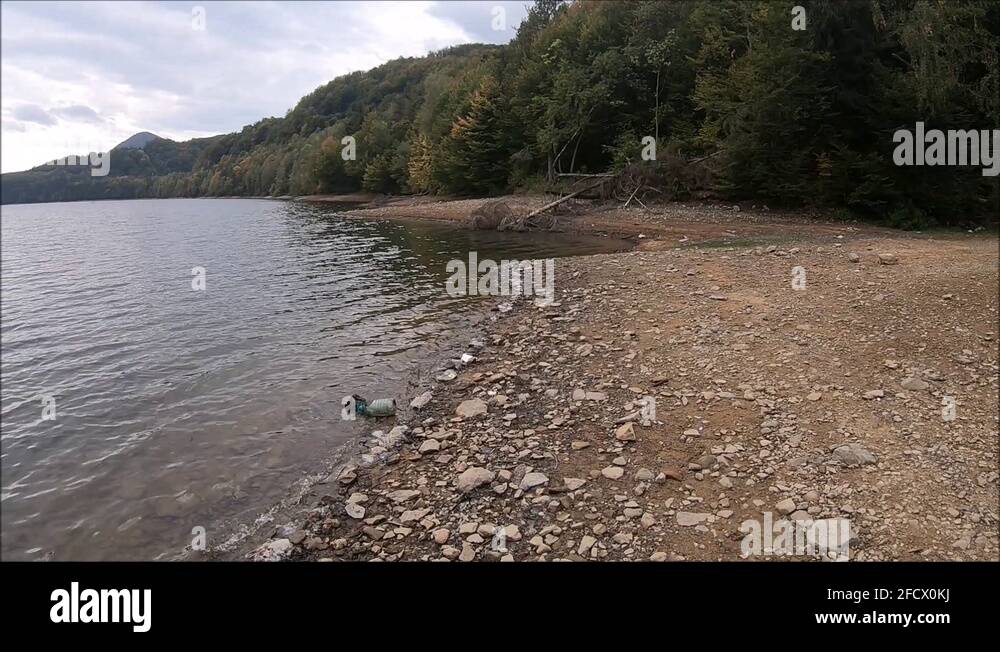 A Rocky Riverbank By The Beautiful, Clean, And Fresh Water River In