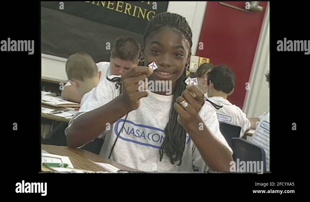 1990s Classroom. Girl puts paper airplanes onto grid. Students play game Stock Video Footage