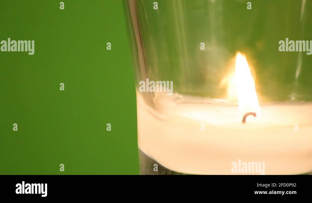 Candle flame flickers in front of green screen background Stock Video