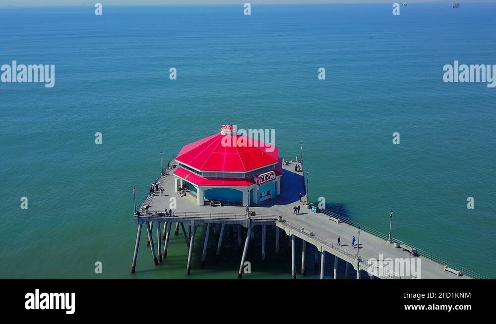 Rotating aerial footage of Ruby's Diner on the Huntington Beach pier ...