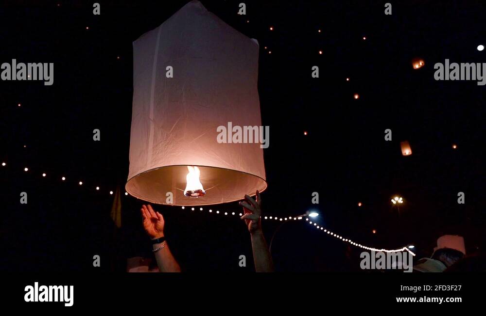 A tourist releasing floating lantern during Yi Peng Festival in Chiang
