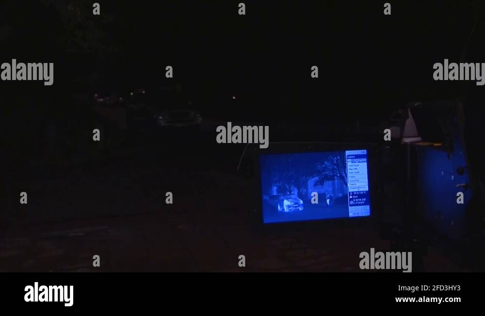 thermal night vision camera displays car and pedestrian in the dark