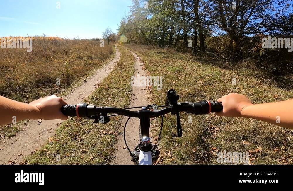 Girl rides bicycle through forest. A man on a bicycle rides in forest