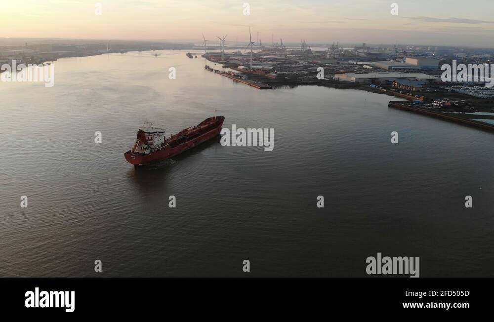 Aerial view of an empty container ship dropping its anchor in the