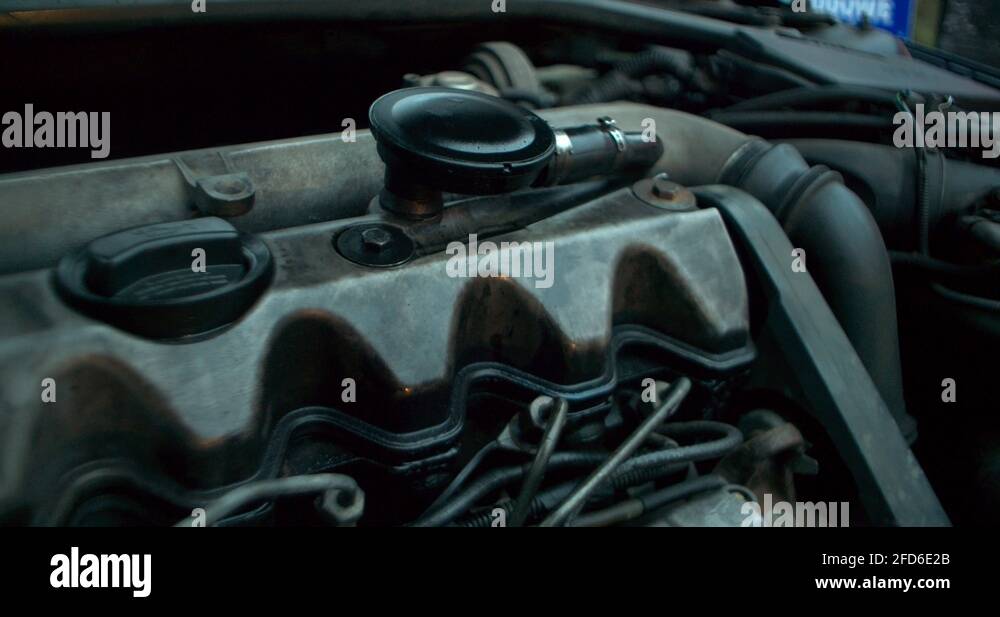 Working engine of the old car under the open hood. oil leakage Stock