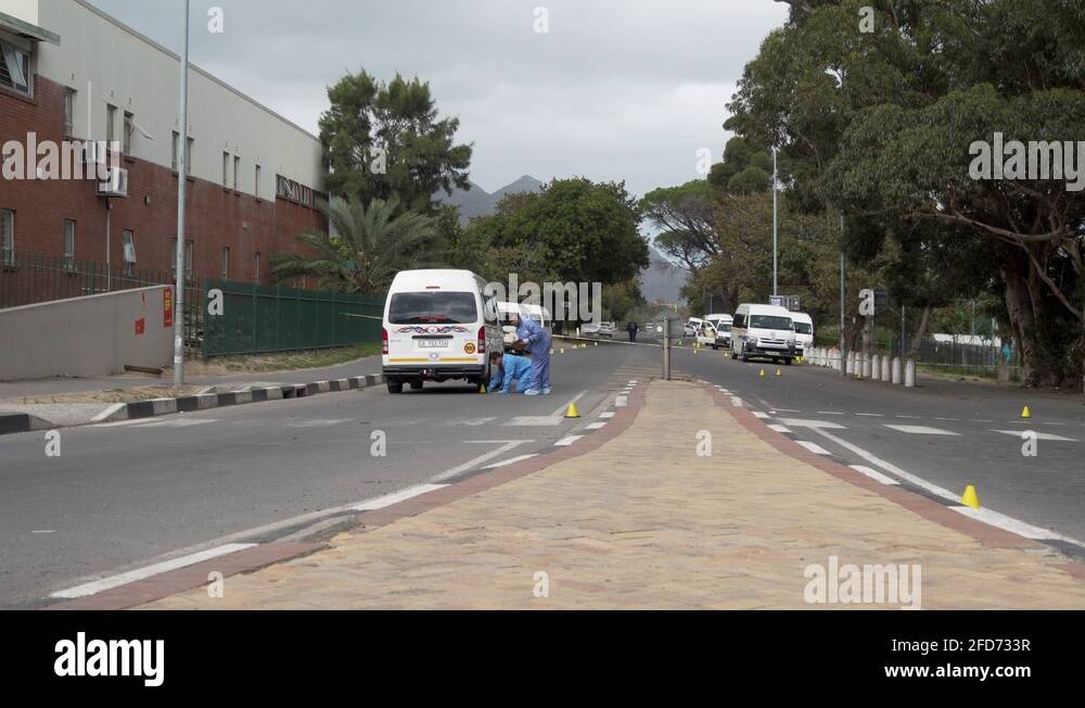 Forensic detectives collect evidence at murder crime scene. South