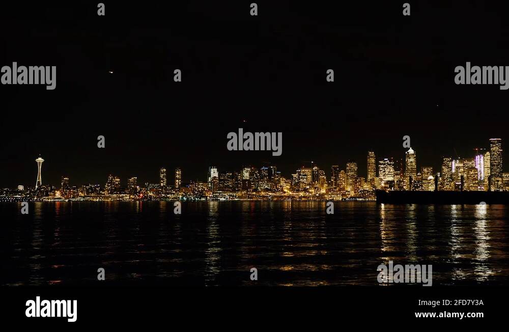 Seattle skyline at night with Space Needle timelapse with cargo ship in ...
