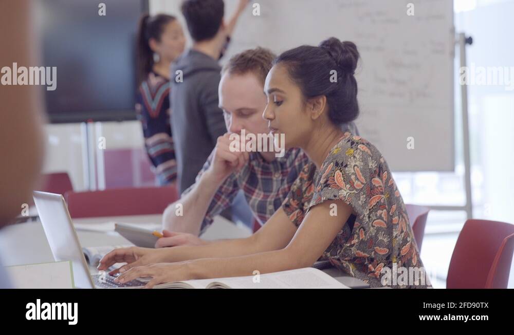 College students studying and using whiteboard in classroom Stock Video Footage Alamy