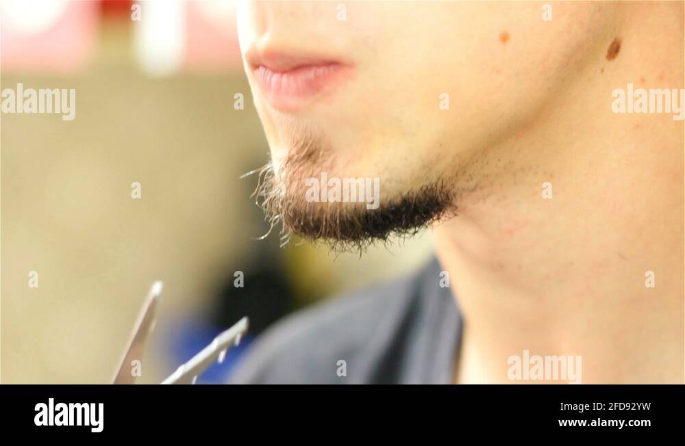 Cutting long facial hair under the chin Stock Video Footage Alamy