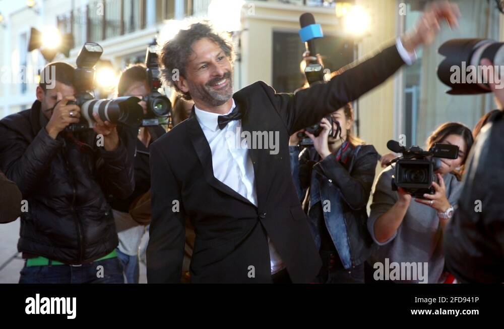 Celebrity waving to paparazzi at red carpet event Stock Video Footage