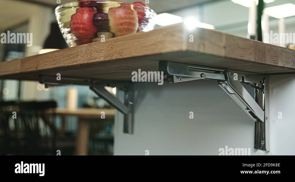 Slow motion footage of woman folding down a mounted table Stock Video