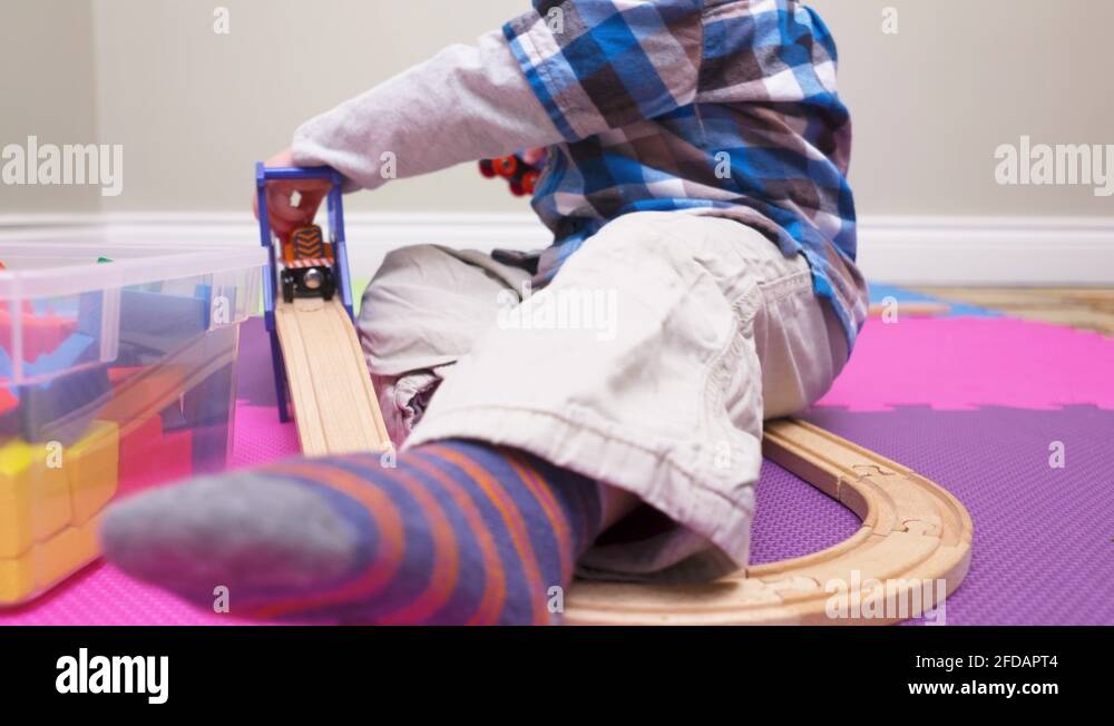 Toddler boy throwing his toy trains in frustration Stock Video Footage