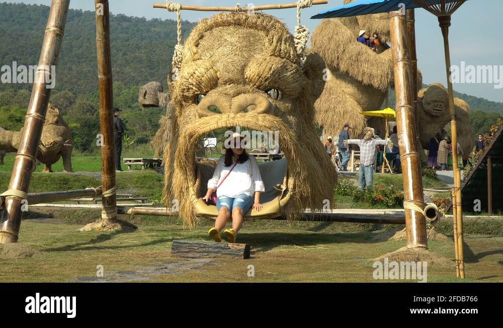 Fun on a King Kong head swing at the Straw sculptures park in Chiang