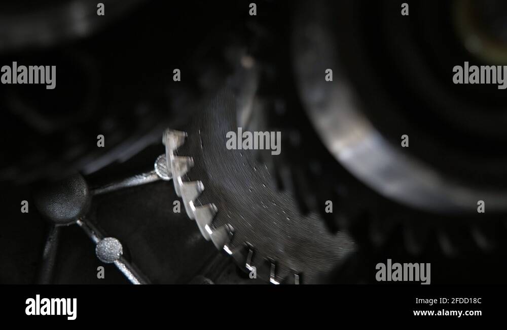 Rotating teeth of three broad cogs riding aslant in a present-day car ...