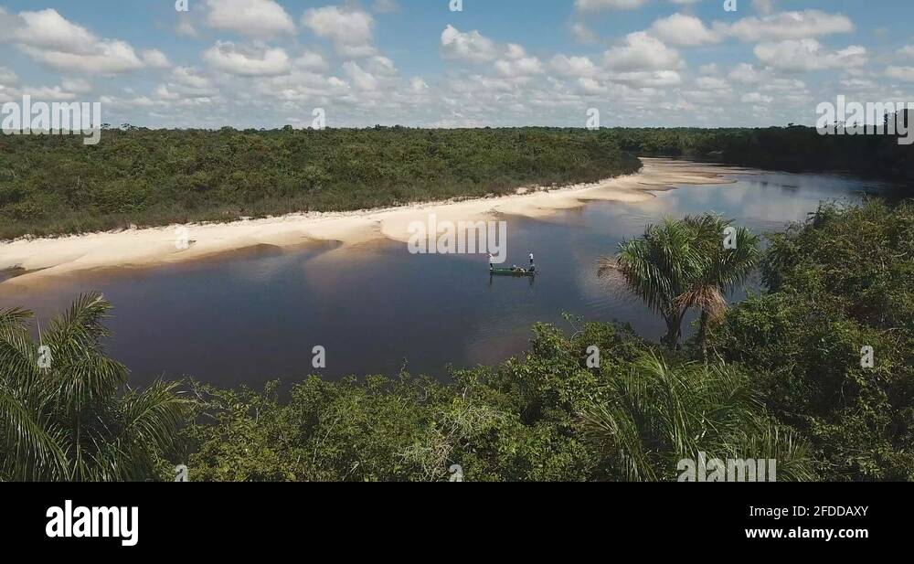 Flying over the amazon rainforest with anglers inside a small boat ...