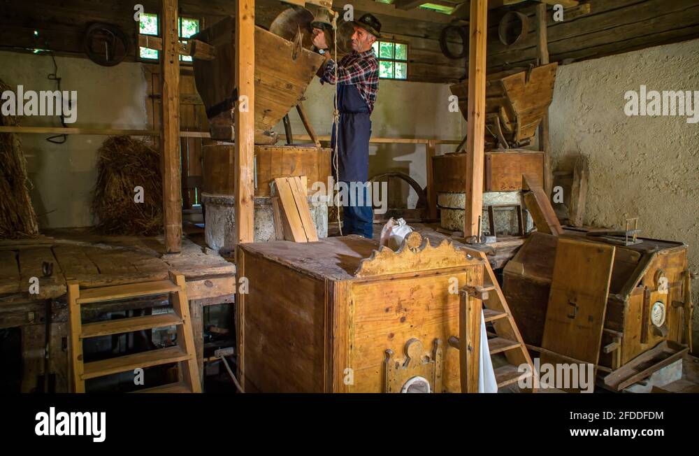 Local OldFashioned Flour Mill with Old Man At Work Grinding Flour