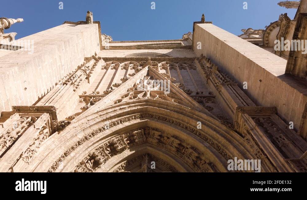 Seville Cathedral Door of Baptism in Spain, Fast High to Low Tilt Down Stock Video Footage Alamy