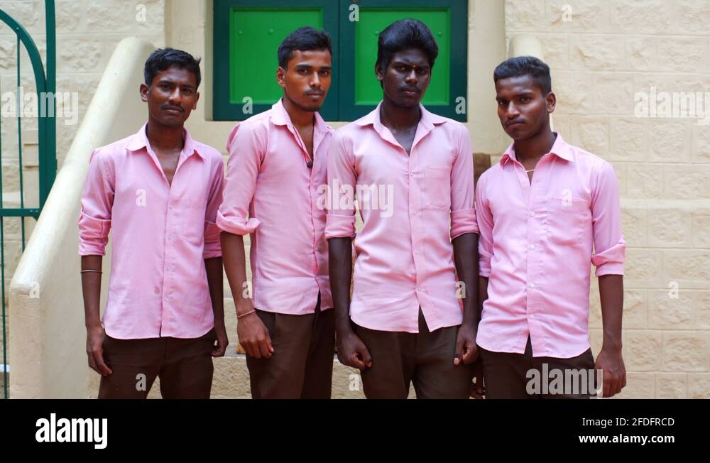 Indian school boys in pink uniform, Sri Ramana Maharshi Ashram, Tamil Nadu India Stock Video