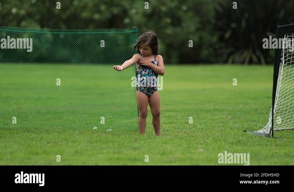 Little girl child checking armpit rash outside, kid looking at mosquito