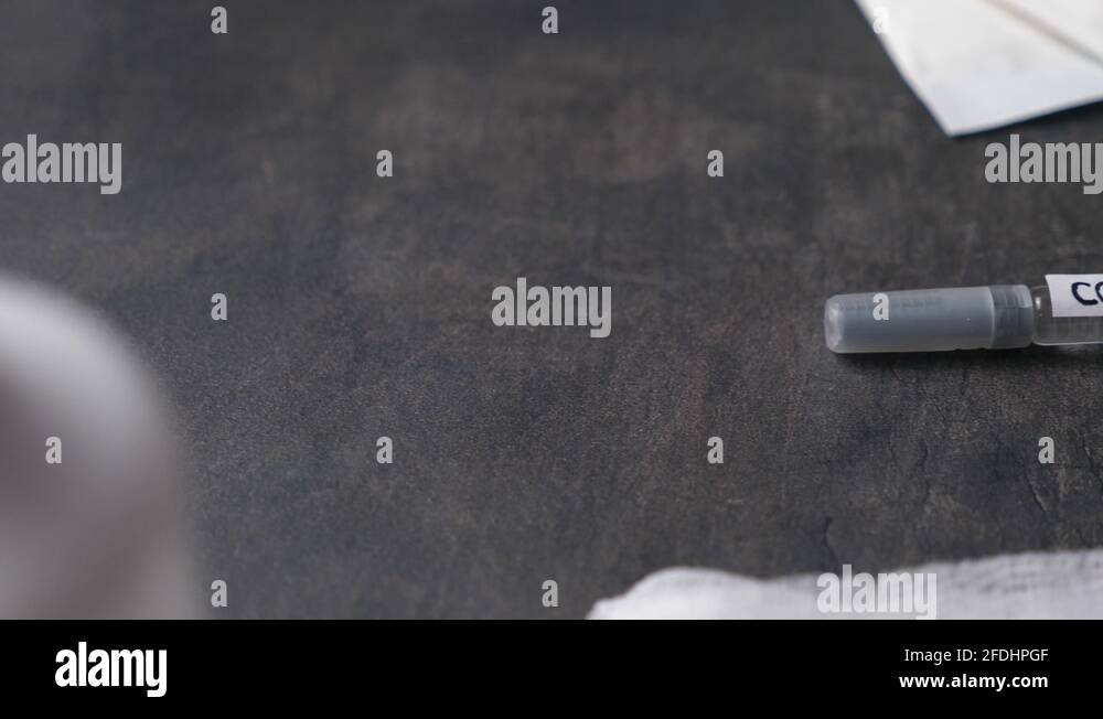 COVID19 TEST syringe laying on a table. Reveal slide shot Stock Video