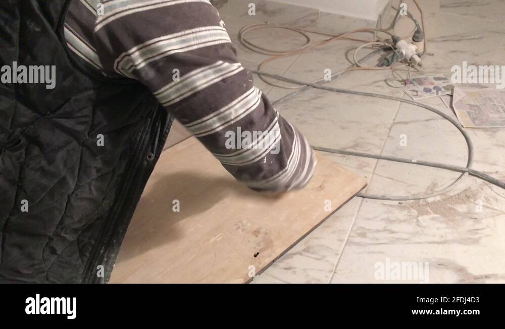 Dusting with the paint brush the sanding waste from wooden board in 4k