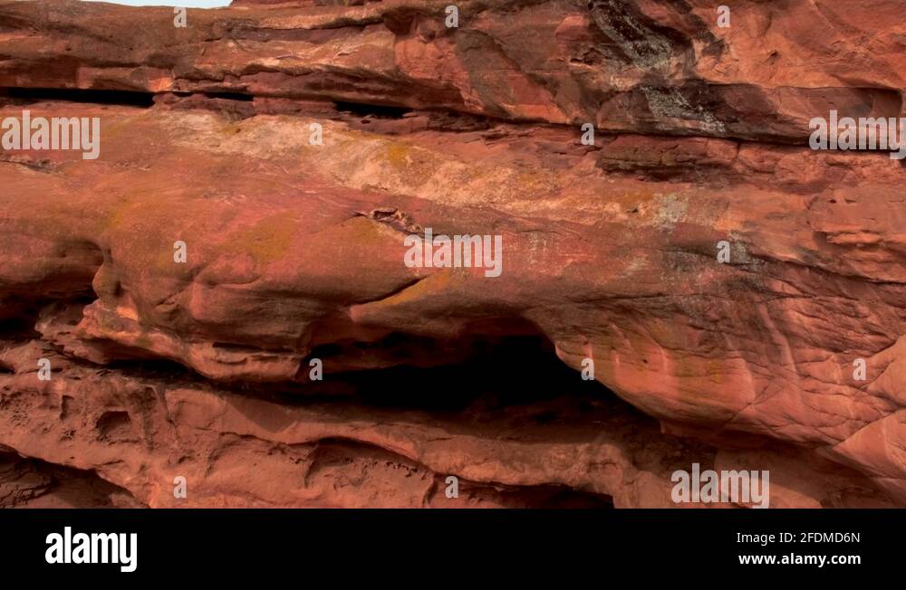 Stunning red rock mountain formation, close up pan up and to right ...