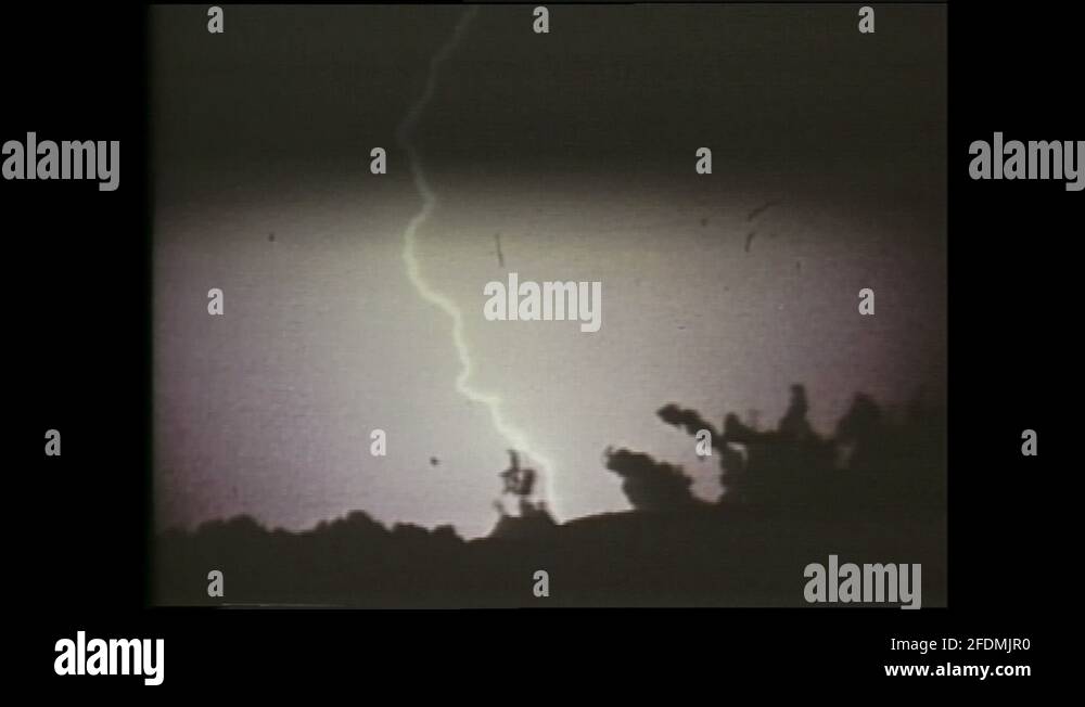 1990s Lightning flashes in sky. Women sit in TV studio, Shelley
