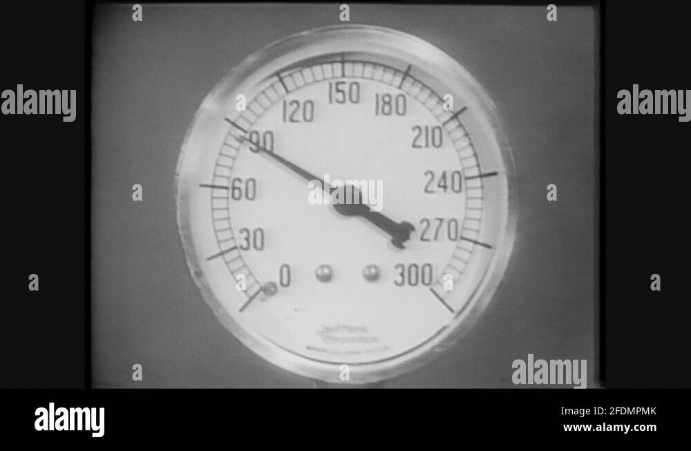 1960s Needle on gauge moves up. Air tanks. Man guides pointer along tubes of Stock Video