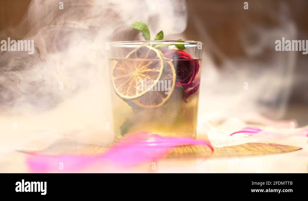 cocktail with iced rose is ready to drink in a smoke cloud, mixology ...